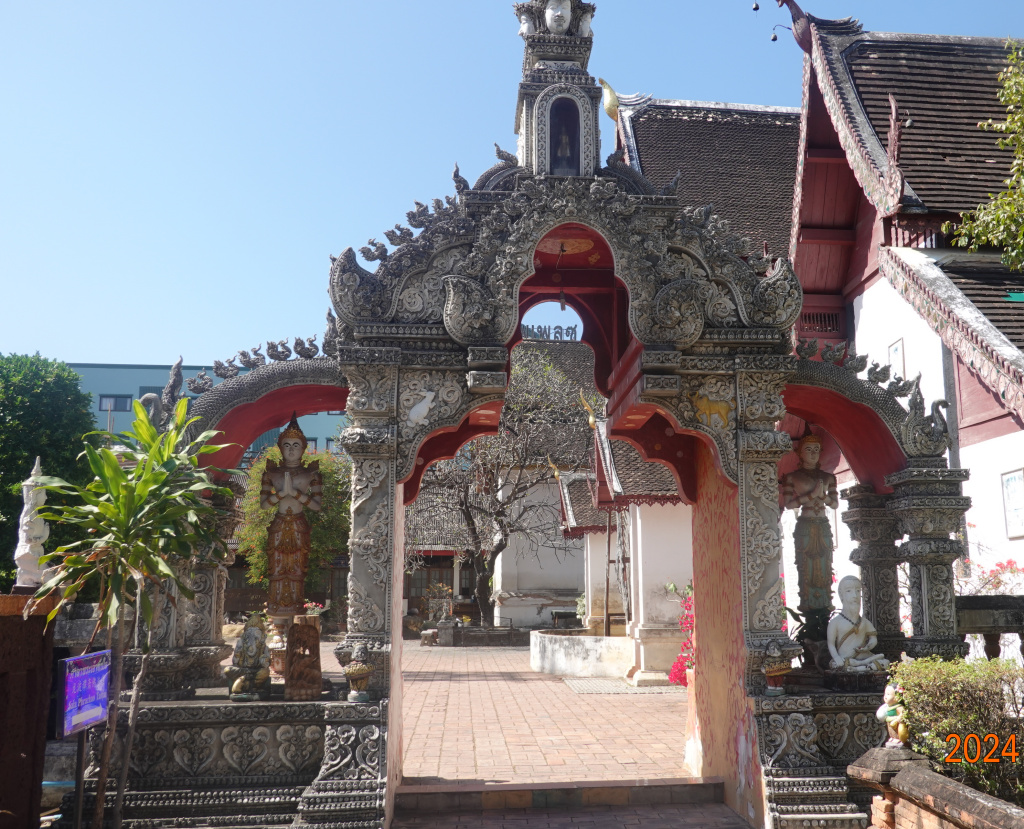 Elaborate, old arched entrance at Wat Buppharam, Chiang Mai, Thailand