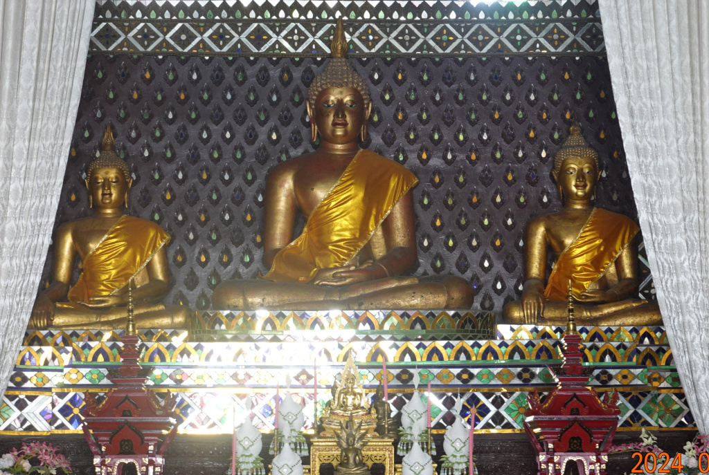 Three gold seated Buddha statues at Wat Buppharam, Chiang Mai, Thailand