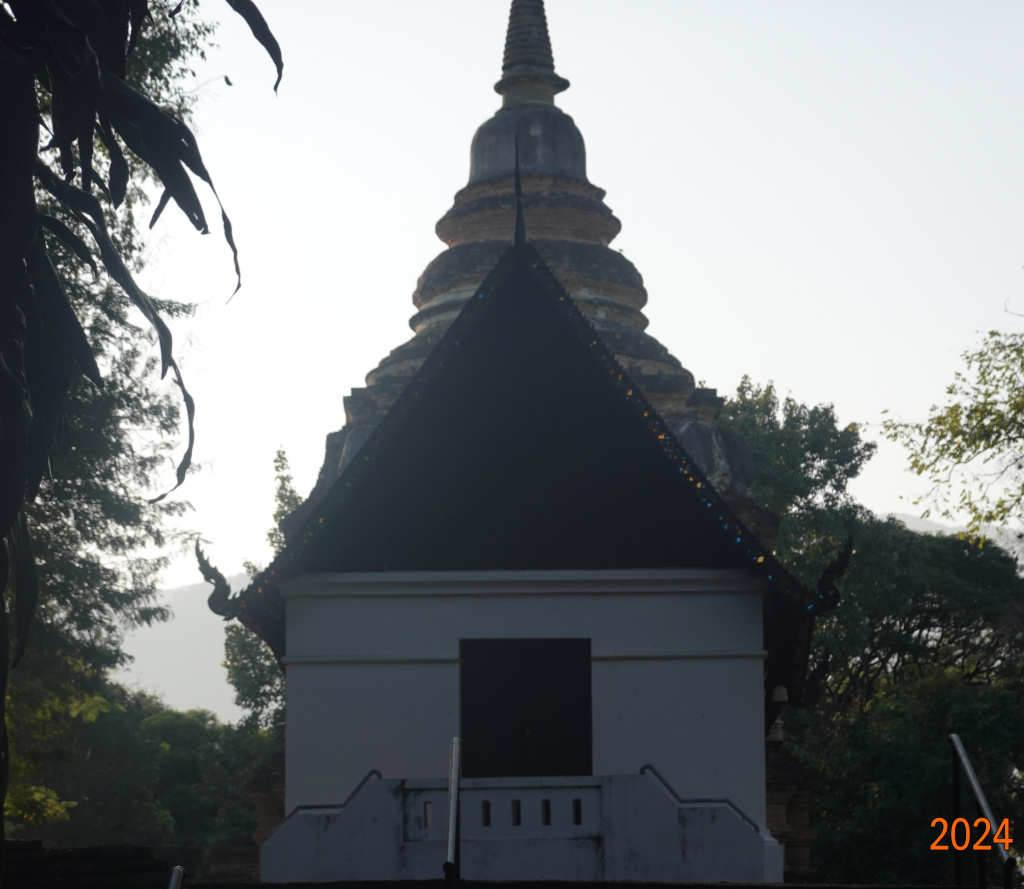 View of ubosot in shadow with chedi behind, Wat Jed Yod, Chiang Mai, Thailand