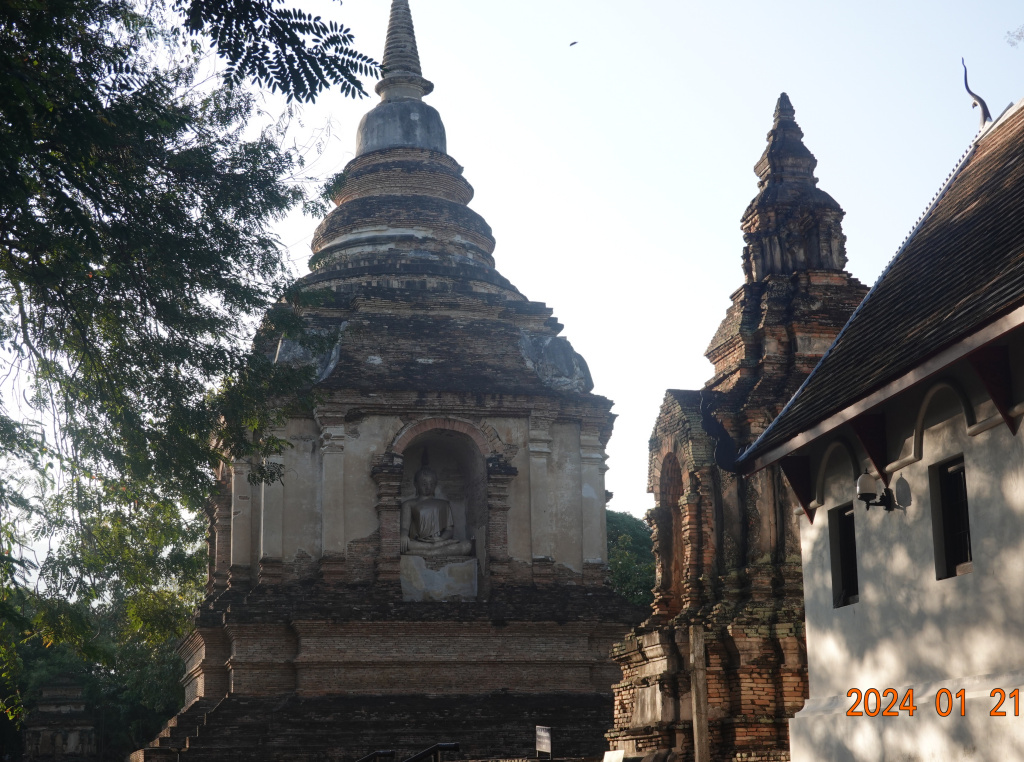 Side view of ubosot with smaller chedi and larger chedi visible, Wat Jed Yod, Chiang Mai, Thailand