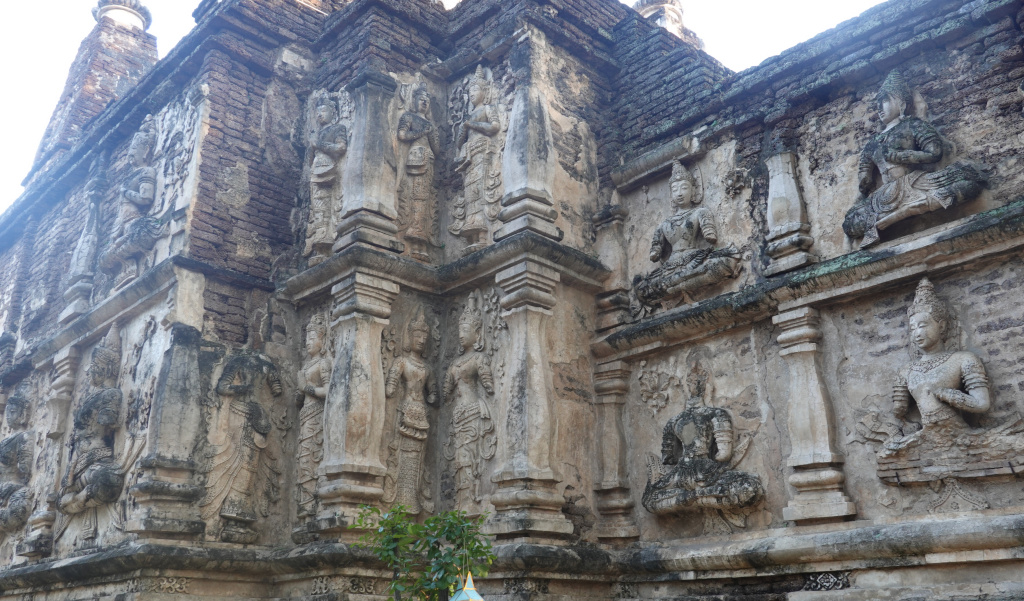 Ancient stucco thewada carvings on viharn side, Wat Jed Yod, Chiang Mai, Thailand
